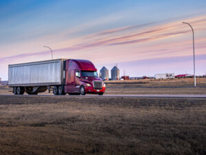 Long-haul truck crossing grassy area