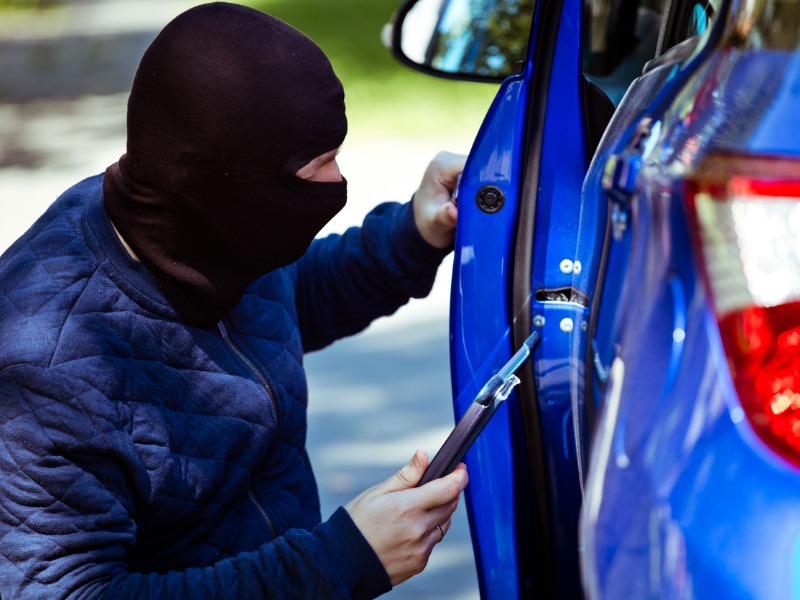 High tech car thief using an tablet to access a car door lock