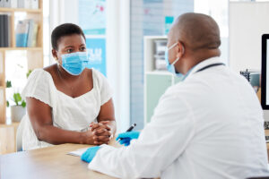 A young woman talks with her gynecologist