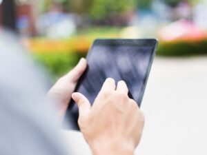 Claims adjuster using a tablet on site at a restoration project