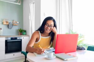 Beautiful young asian woman with glasses working from home