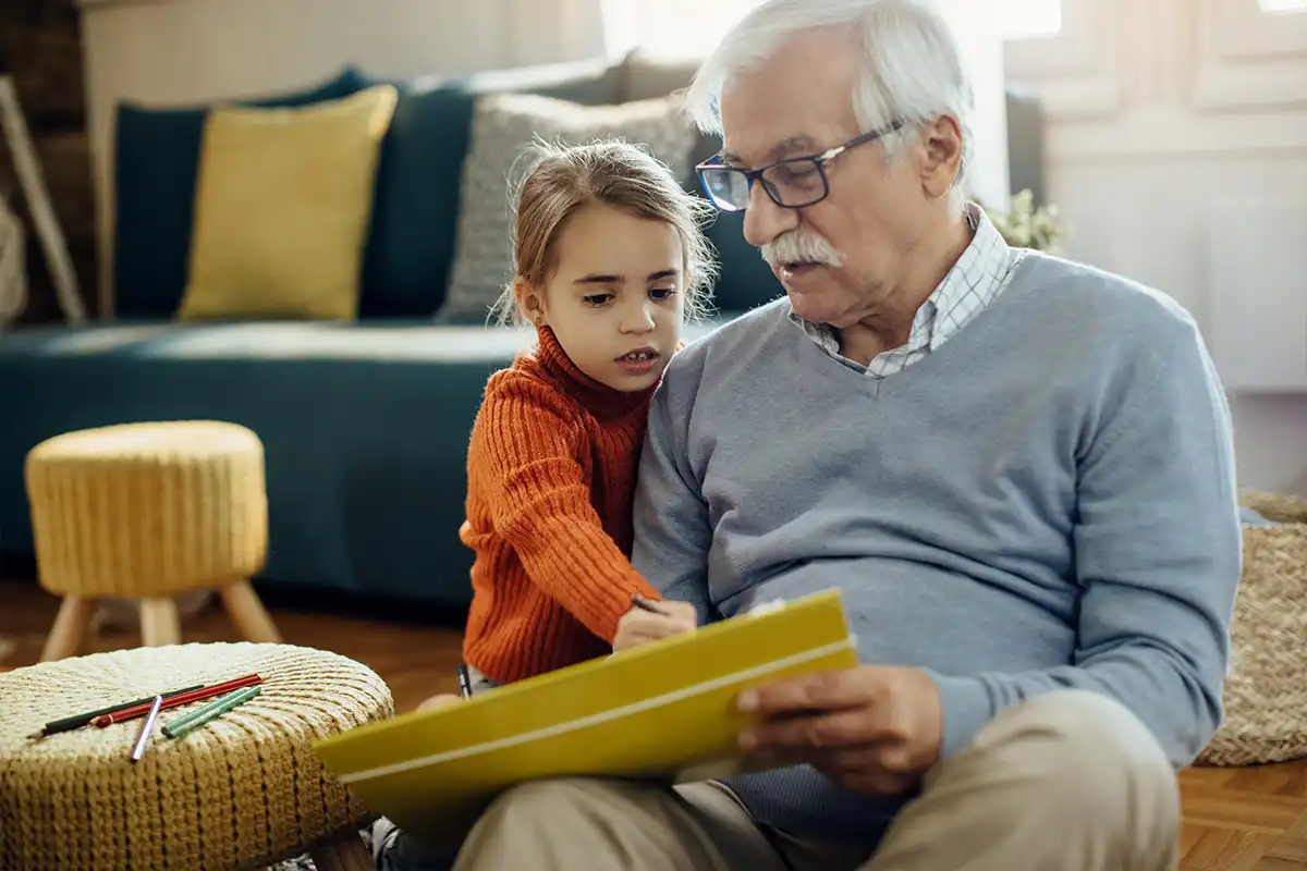 A little girl and her grandfather enjoy creative time together