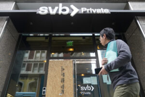 A pedestrian passes a Silicon Valley Bank Private branch in San Francisco, Monday, March 13, 2023. Depositors withdrew savings and investors broadly sold off bank shares Monday as the federal government raced to reassure Americans that the banking system was secure after two bank failures. Regulators closed the Silicon Valley Bank on Friday after depositors rushed to withdraw their funds all at once. (AP Photo/Jeff Chiu)