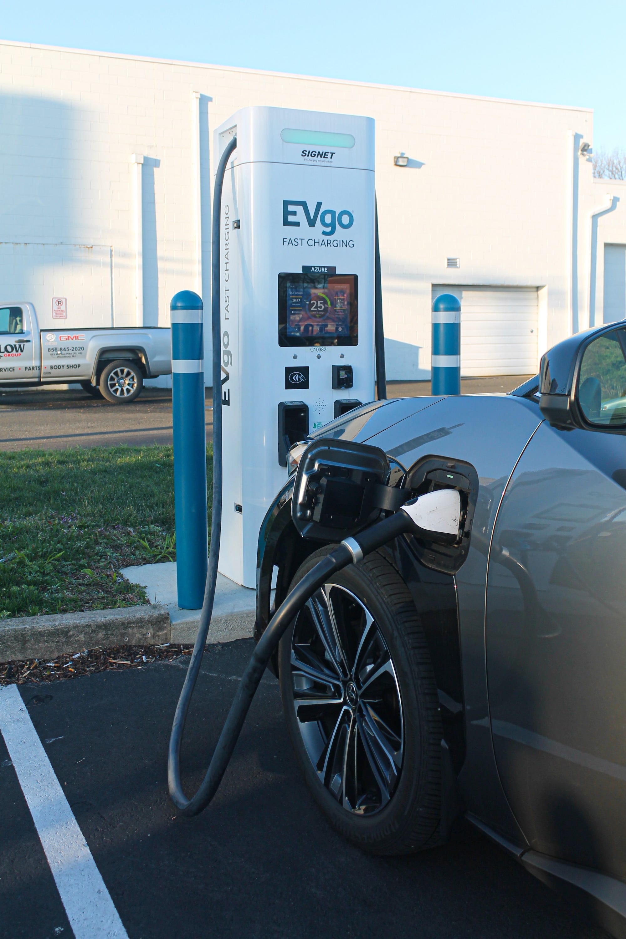 A charging cable is shown plugged into the 2023 Toyota bZ4X AWD Limited electric SUV.