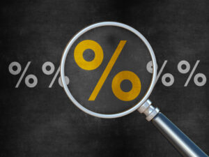 Magnifying glass looking at percent symbol