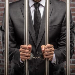 Man in prison behind bars