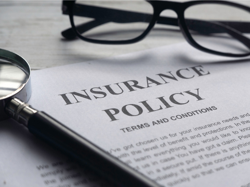 Selective focus of magnifying glass and insurance policy on an insurance policy