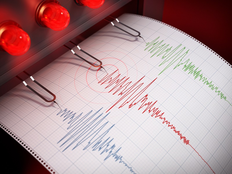 Seismograph printing seismic activity records of a severe earthquake