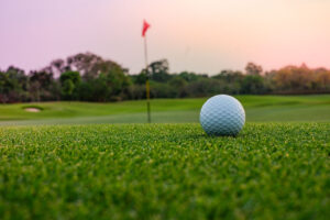 A long putt on the  green as sunset closes in