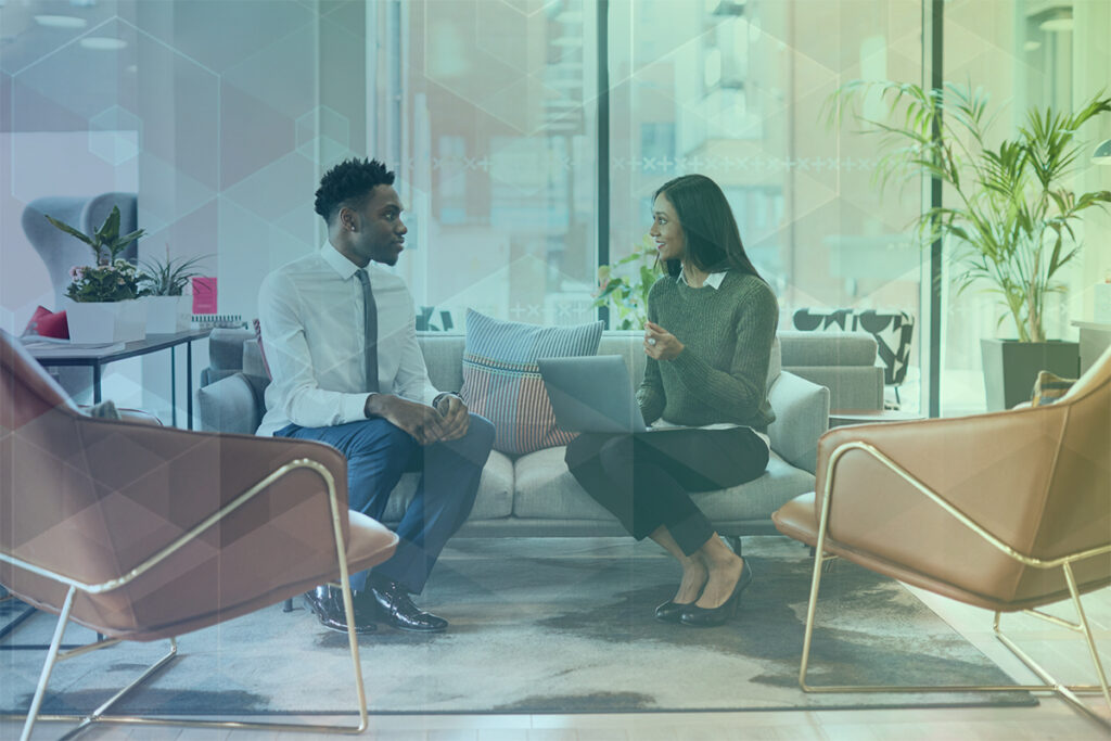 A young woman conducts a conversational interview in a sunny office