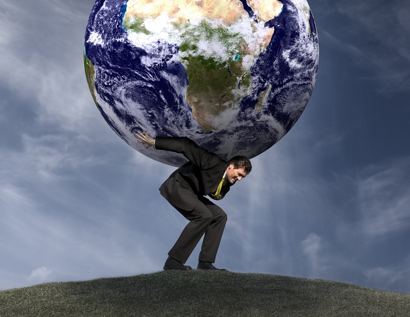 Conceptual image of a businessman as Atlas with the world on his shoulders.