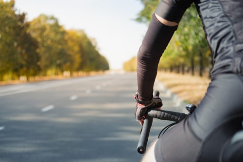 Arm warmers on person cycling bike in spring