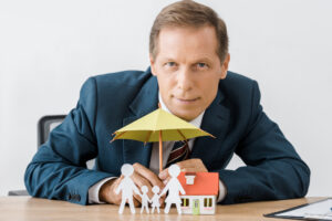 Life Insurance Agent sitting at desk, reviewing policies