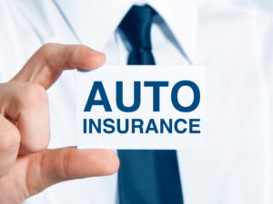 Man holding a card that reads 'auto insurance'