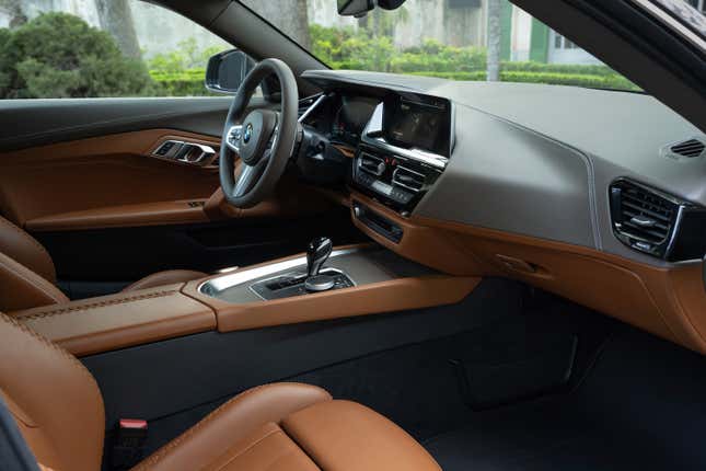 The interior of the BMW shooting brake concept car as seen through the passenger side door opening. It's mostly brown with gray leather on the dash.