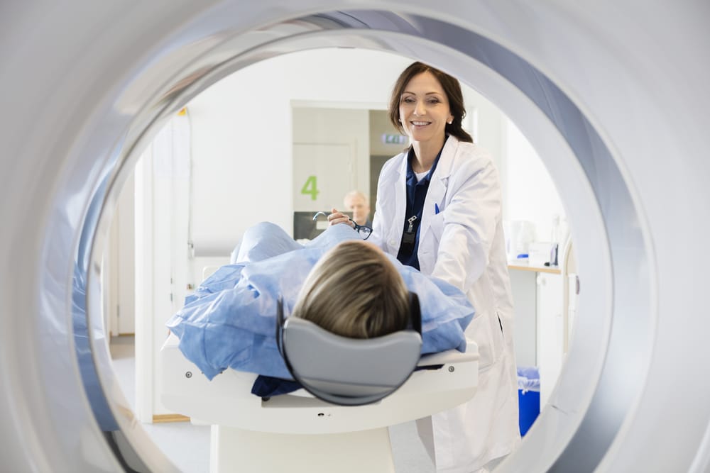 woman radiologist with patient getting a CT scan