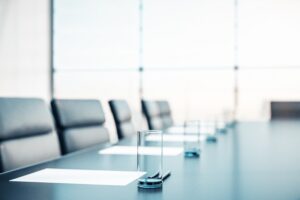 Close up of conference room with glasses of water on the table with papers, armchairs and a large window. 3D Rendering