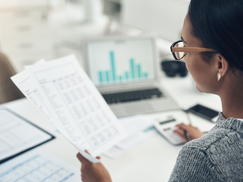 Businesswoman calculating finances in an office