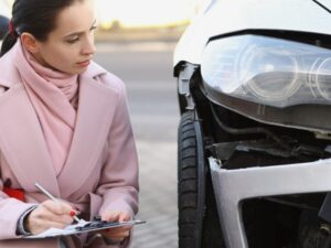 Adjuster filling out a car accident assessment form