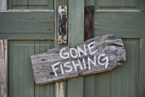 "gone fishing" sign stapled to the door