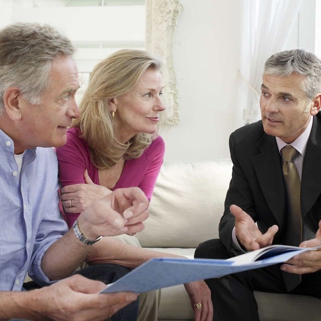 Man advising an older couple