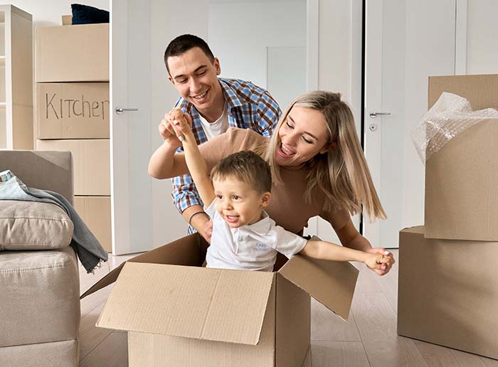 Young couple with a toddler moving into their first new home