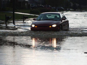 Car driving through floodwaters