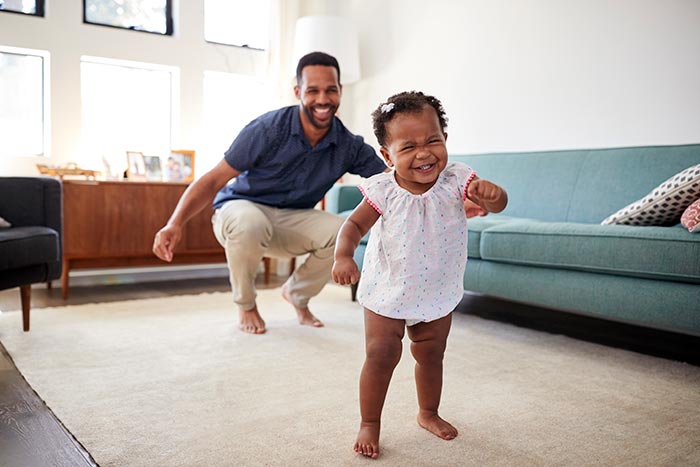 Father and daughter playing together in their living room