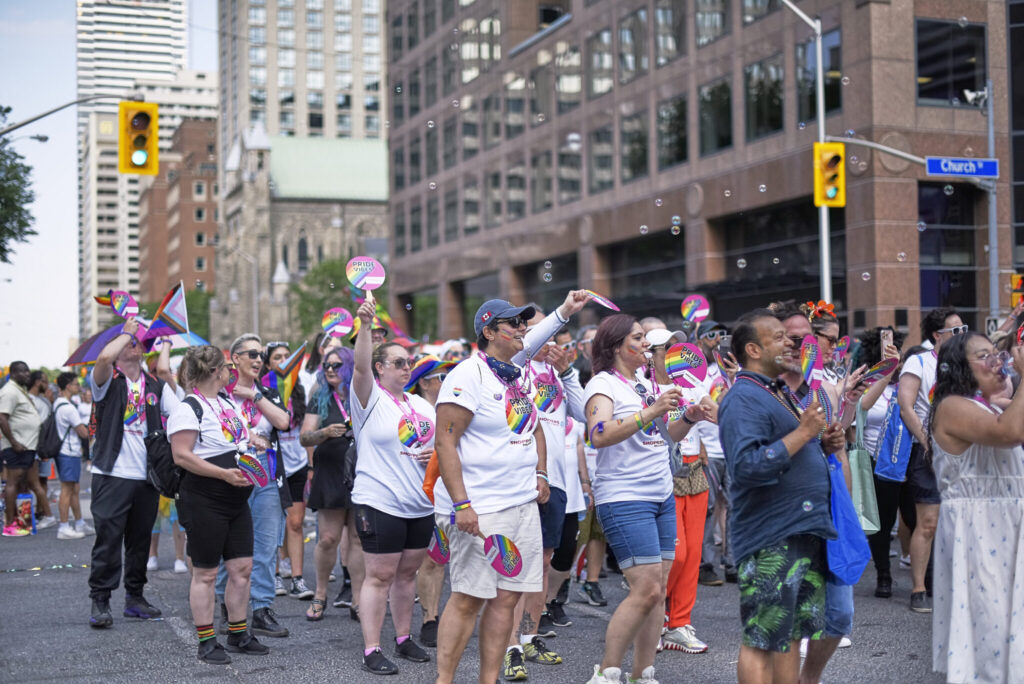 Toronto Ontario, Canada- June 26th, 2022: Shoppers Drug Mart employees marching with signs during Toronto’s annual Pride parade.