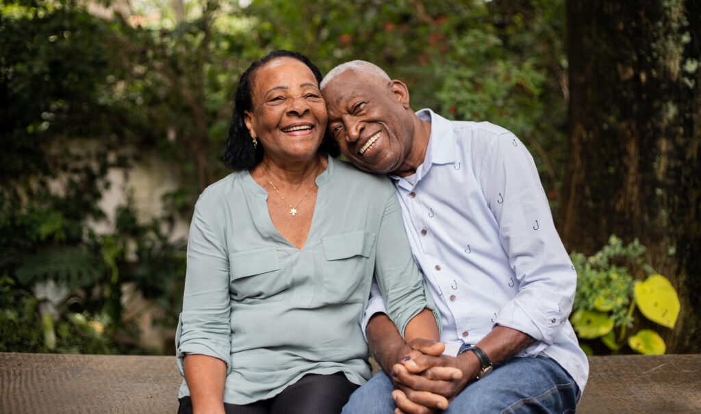 Portrait of a happy senior couple sitting together outdoors