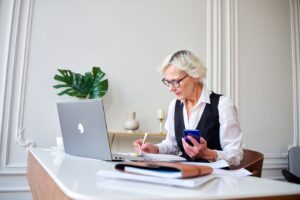 Mature woman accountant counts taxes