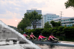 Members of a WeCanRow team row on the Schuylkill River