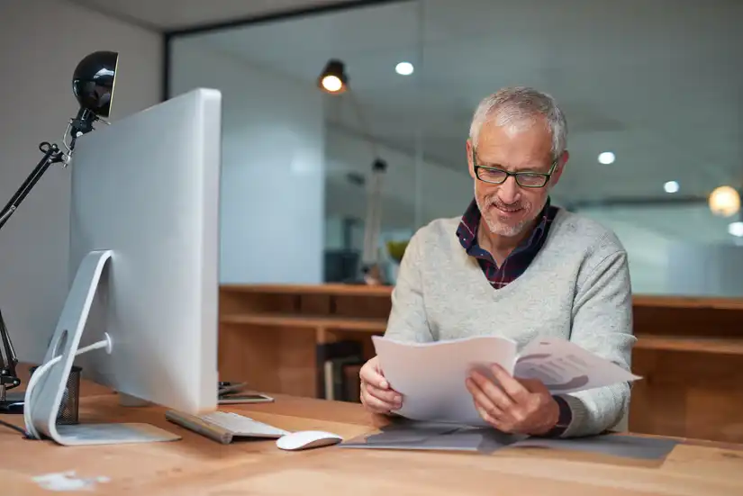 Man reading health insurance policy small print