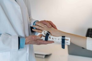 doctor putting a cast on patient's wrist