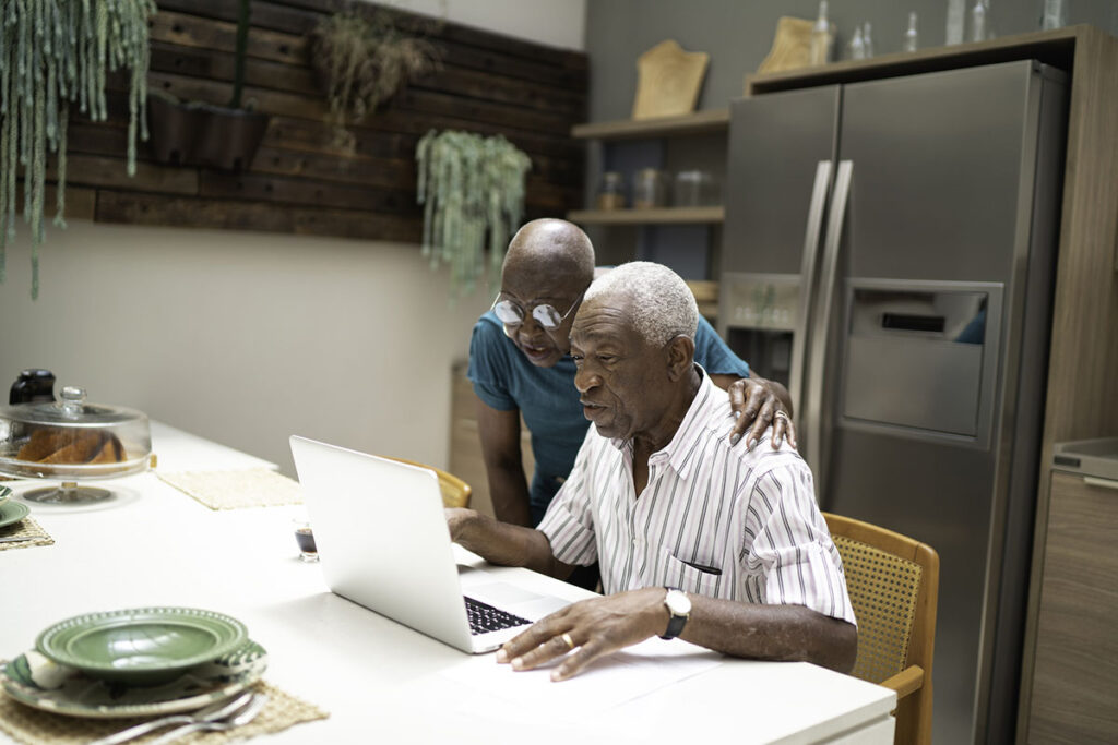A senior couple looks over information about Advance Care Planning on the computer