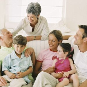 A multi-generational family sitting on a couch