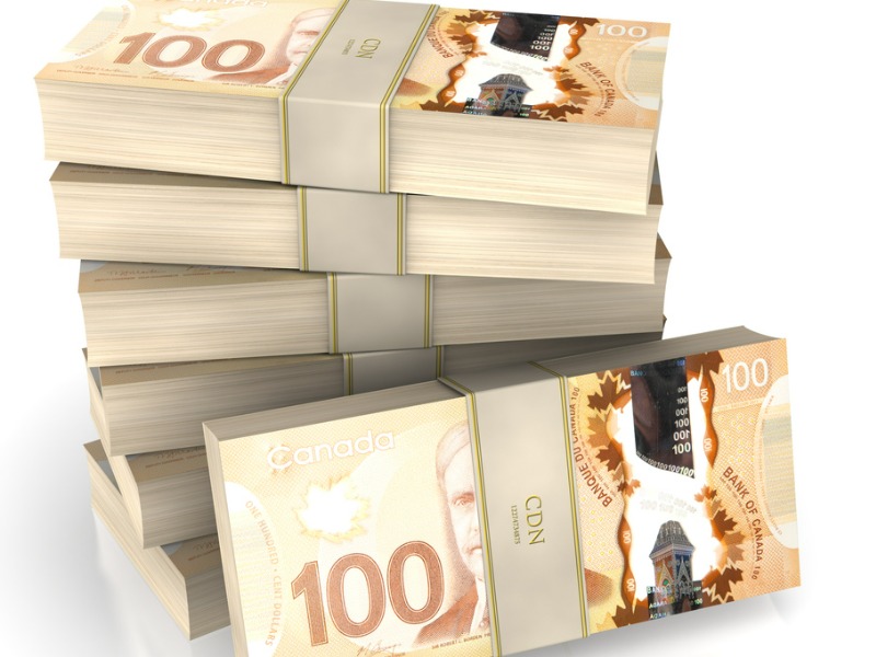 Piles of Canadian money representing investment in insurance capacity.