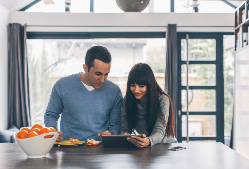 Young Couple Browsing On A Computer Tablet In The Morning