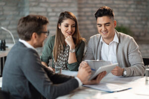 Young couple meeting with their life insurance agent to find out if they need life insurance.