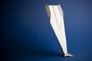 Paper airplane on blue background