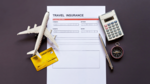 Travel insurance papers on desk with miscellaneous items