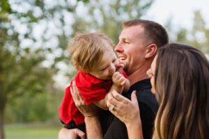 Parents hold and laugh with young son