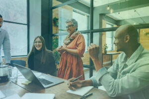 A group of coworkers engage in a creativity exercise in a conference room.