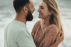 Husband and wife are at the water's edge