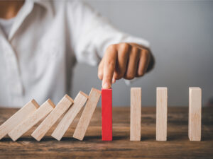 Hand of a businessman stopping a falling block