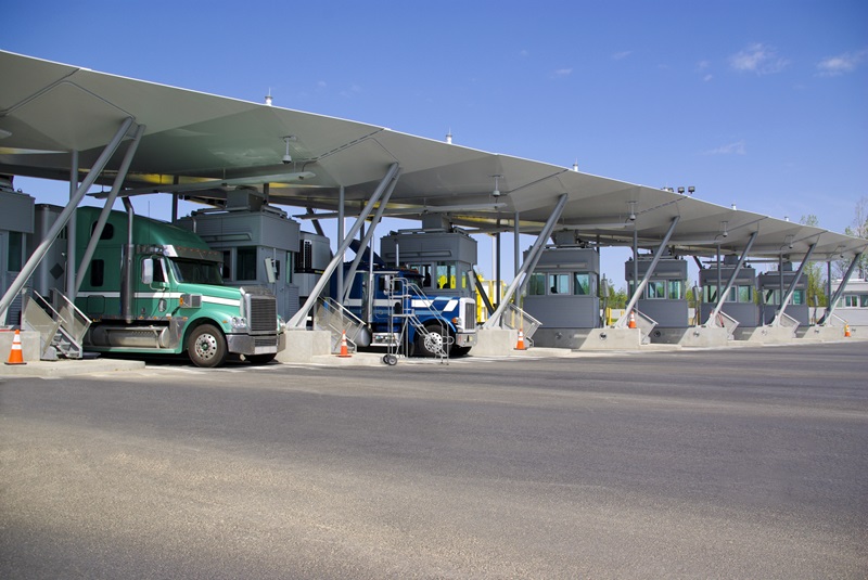 Canadian border with the USA. Canadian customs. Semi-trucks paying at toll booths