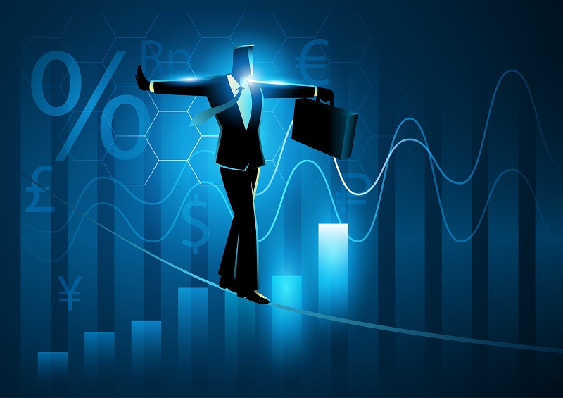 Businessman walking on tightrope on graphic chart and currency symbols