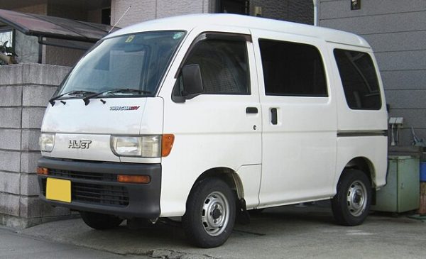 White Daihatsu Hijet kei car van parked outside