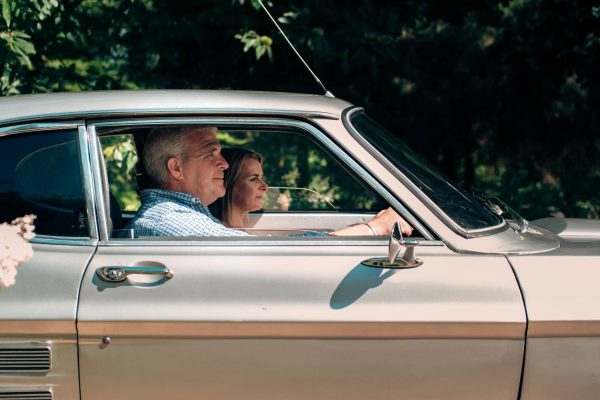 Couple sitting in classic car