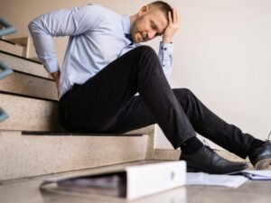 Office worker who has fallen on a staircase